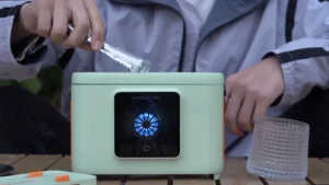 Compact portable countertop ice maker producing fresh ice cubes in minutes on a kitchen counter